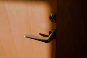 Silver lever handle and lock on a wooden door