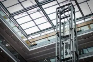 Glass lift structure in a bright modern atrium