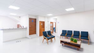 Bright medical centre waiting room with reception counter and seating